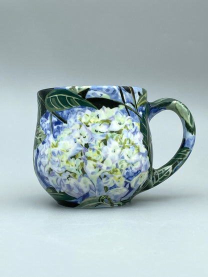 Ceramic mug with floral design on a plain background